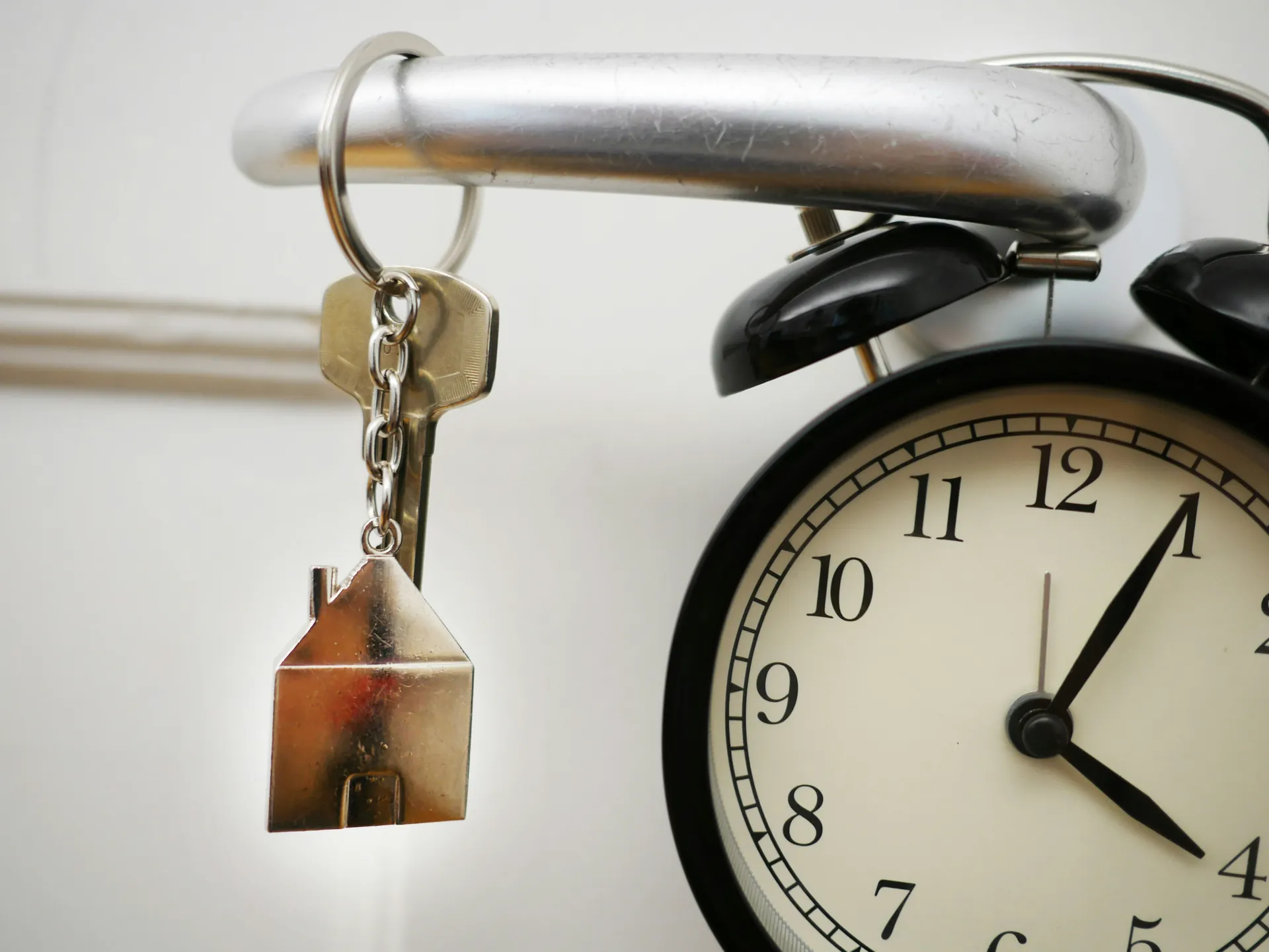 réveil et clé sur une poignée de porte 