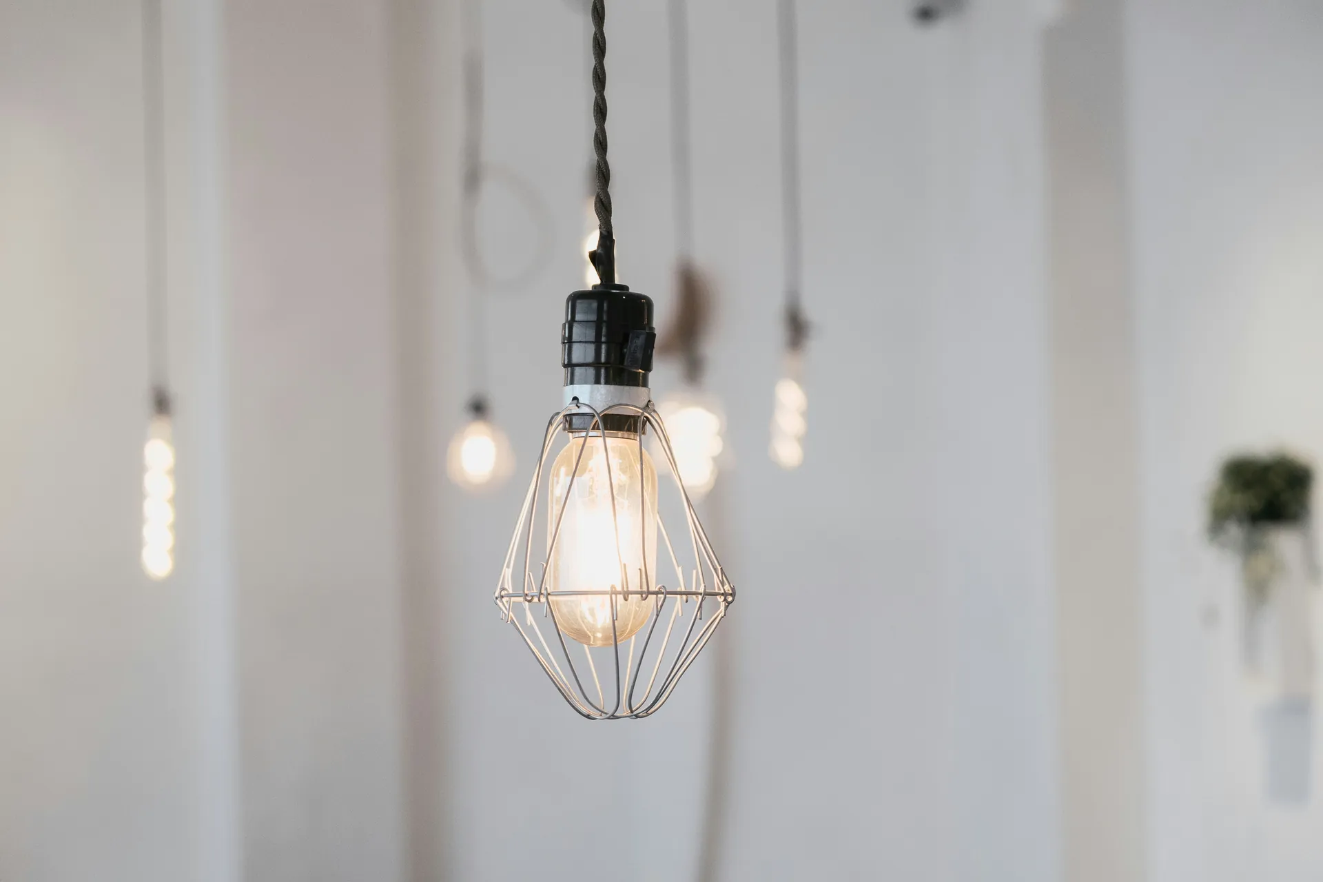Single lit bulb in a minimal setting representing energy-saving tips to reduce household bills